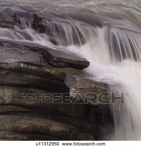 Stock Image - Waterfall over rocks. Fotosearch