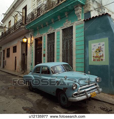 An antique car parked in an alley View Large Photo Image Stock Photo - An antique car parked in an alley. Fotosearch