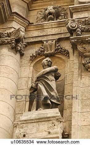 Low angle view of a stone statue mounted on a building View Large Photo Image Picture - Low angle view of a stone statue mounted on a building. Fotosearch