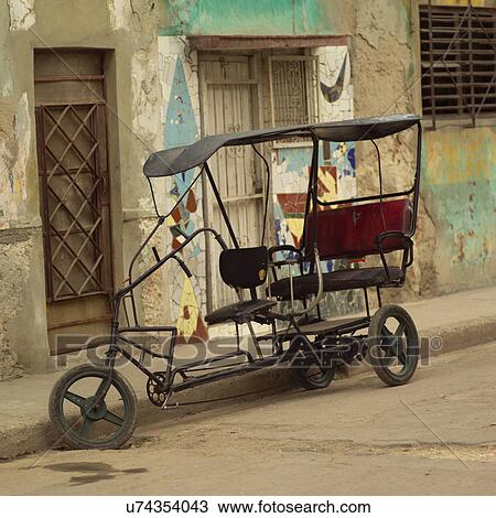 pedicab parked on the side of a street View Large Photo Image Stock Image - pedicab parked on the side of a street. Fotosearch