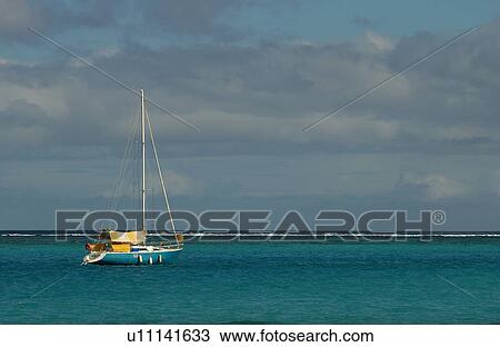 Stock Image - A sailboat on the sea, Moorea, Tahiti, French Polynesia, South Pacific. Fotosearch