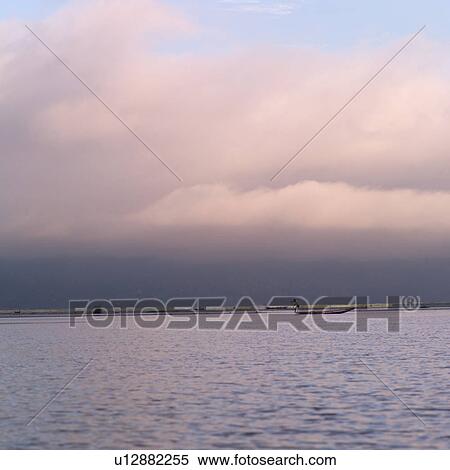 Stock Photography - Dark skies over Inle Lake. Fotosearch