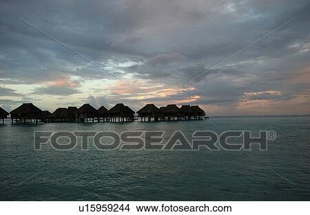 Picture - Panoramic view of thatched buildings on stilts in the sea, Moorea, Tahiti, French Polynesia, South Pacific. Fotosearch