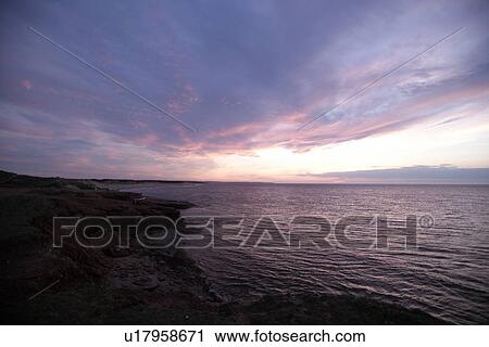 Stock Image - Sunset over the coast in Prince Edward Island, Canada. Fotosearch