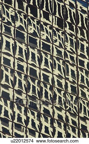 Glass facade of a high-rise building View Large Photo Image Picture - Glass facade of a high-rise building. Fotosearch