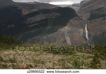 Stock Image - A rainbow seen on Rocky Mountains, Canada. Fotosearch
