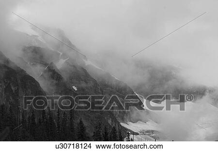 Picture - Fog enveloping a mountain, Rocky Mountains, Canada. Fotosearch