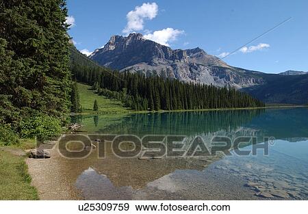 Lake near a mountain, Rocky Mountains, Canada View Large Photo Image Stock Photo - Lake near a mountain, Rocky Mountains, Canada. Fotosearch