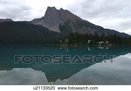 Reflection of a mountain in a lake Rocky Mountains, Canada View Large Photo Image Stock Image - Reflection of a mountain in a lake Rocky Mountains, Canada. Fotosearch