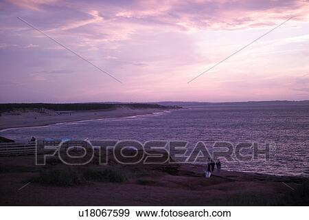 Stock Photo - Silhouette of people at the beach in Prince Edward Island, Canada. Fotosearch
