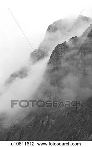 Stock Image - Fog enveloping a mountain, Rocky Mountains, Canada. Fotosearch