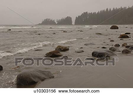 Stock Photograph - Beach on a cloudy day, Florencia Bay, Vancouver Island, Canada. Fotosearch