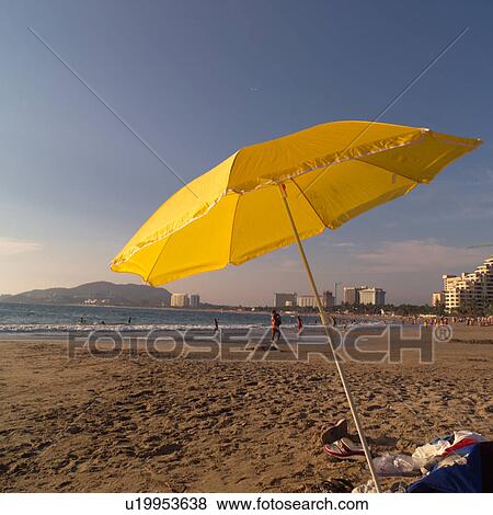 Yellow Umbrella on the beach View Large Photo Image Stock Photo - Yellow Umbrella on the beach. Fotosearch