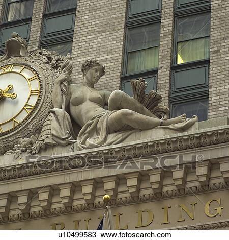 Clock and sculpture on Building View Large Photo Image Stock Image - Clock and sculpture on Building. Fotosearch