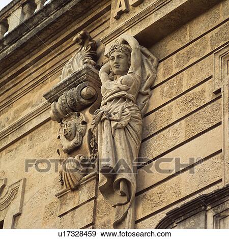 Low angle view of a stone statue on a building View Large Photo Image Stock Photo - Low angle view of a stone statue on a building. Fotosearch