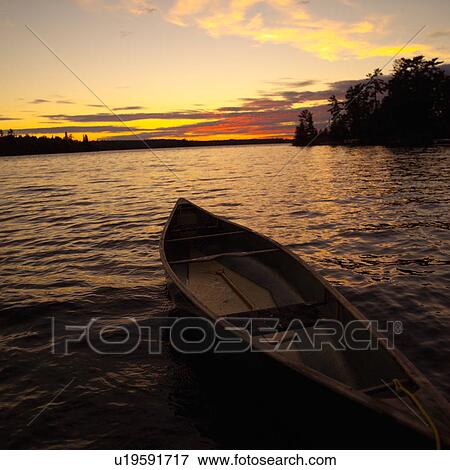 Boat on a lake at sunset on Lake of the woods, Ontario, Canada View Large Photo Image Stock Photo - Boat on a lake at sunset on Lake of the woods, Ontario, Canada. Fotosearch