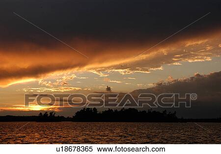 Stock Photography - Panoramic view of a sunset at Lake of the woods, Ontario, Canada. Fotosearch