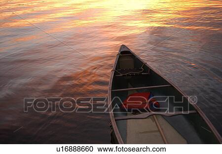 Canoe floating on a lake View Large Photo Image Stock Image - Canoe floating on a lake. Fotosearch