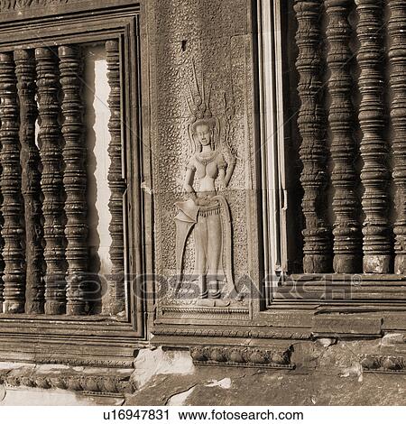 Stock Image - Carved Figurine on Walls of Khmer Kingdom palace ruins. Fotosearch