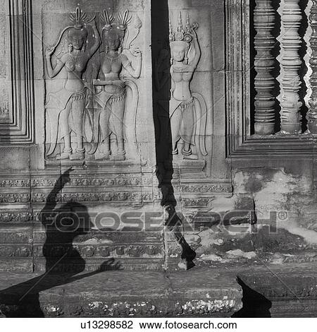 Stock Image - Carved Figurines on Walls of Khmer Kingdom palace ruins. Fotosearch