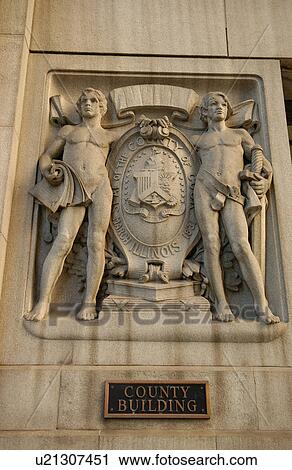 Stock Image - Carved stone statue on County Building. Fotosearch