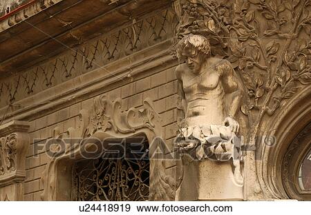 Stock Photo - Low angle view of a stone statue mounted on a building. Fotosearch