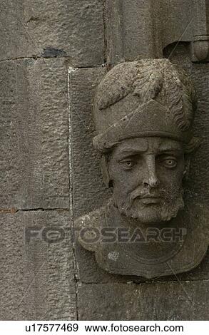 Sculpted face on side of stone wall View Large Photo Image Stock Photo - Sculpted face on side of stone wall. Fotosearch