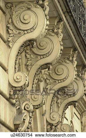 Stone carvings under a balcony of a building View Large Photo Image Picture - Stone carvings under a balcony of a building. Fotosearch