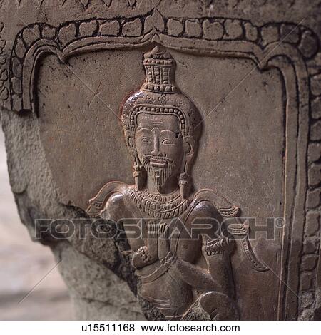 Stock Photo - Carved Figurine on Walls of Khmer Kingdom palace ruins. Fotosearch