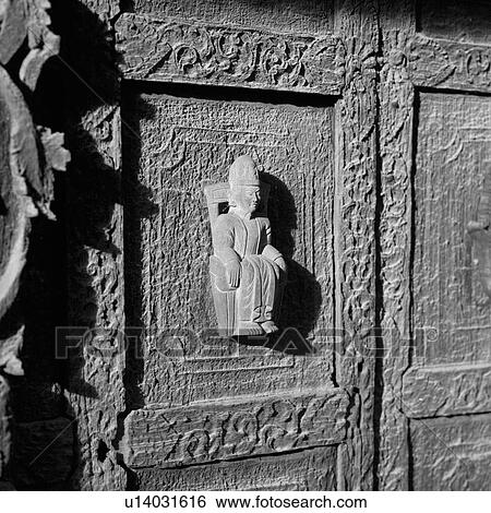 Statue carved on exterior wall of Buddhist Monastery View Large Photo Image Stock Photograph - Statue carved on exterior wall of Buddhist Monastery. Fotosearch