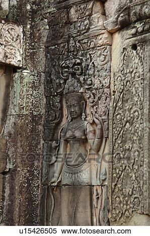 Stock Photography - Statue on wall of Khmer Kingdom palace ruins. Fotosearch