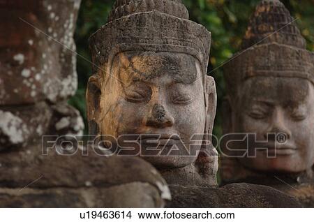 Stone carving of a face at Khmer Kingdom palace ruins View Large Photo Image Picture - Stone carving of a face at Khmer Kingdom palace ruins. Fotosearch