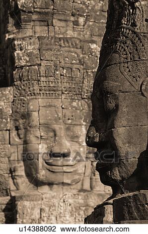 Stone carving of a face on wall at Khmer Kingdom palace ruins View Large Photo Image Stock Image - Stone carving of a face on wall at Khmer Kingdom palace ruins. Fotosearch