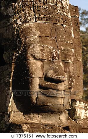 Stone carving of a face on wall at Khmer Kingdom palace ruins View Large Photo Image Stock Image - Stone carving of a face on wall at Khmer Kingdom palace ruins. Fotosearch