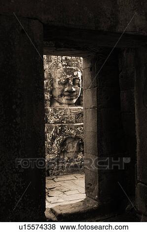 Stock Photo - Stone carving of a face on wall at Khmer Kingdom palace ruins. Fotosearch