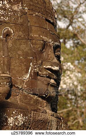Stone carving of a face on wall at Khmer Kingdom palace ruins View Large Photo Image Stock Photograph - Stone carving of a face on wall at Khmer Kingdom palace ruins. Fotosearch