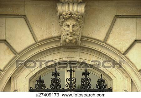 Stone sculpture above an archway of a building in Paris, France View Large Photo Image Stock Photo - Stone sculpture above an archway of a building in Paris, France. Fotosearch
