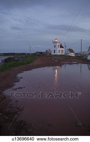 Lit light house on the coast in Prince Edward Island, Canada View Large Photo Image Stock Image - Lit light house on the coast in Prince Edward Island, Canada. Fotosearch