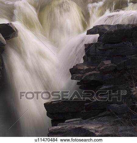 Picture - Waterfall over rocks. Fotosearch