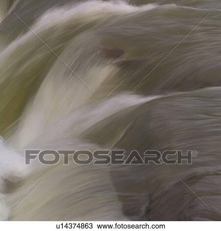 Stock Image - Waterfall over rocks. Fotosearch