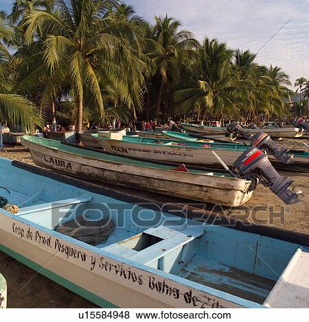 Boats lined up at shoreline View Large Photo Image Stock Photo - Boats lined up at shoreline. Fotosearch