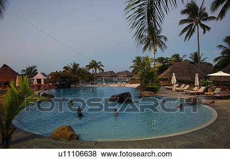 Stock Photo - People in a swimming pool at a seaside resort, Moorea, Tahiti, French Polynesia, South Pacific. Fotosearch