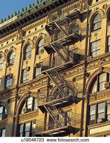 Stock Image - Fire escape on exterior of building, New York City. Fotosearch