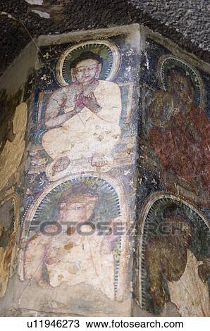 Stock Image - Fresco of Buddha on the column of a cave, Ajanta, Maharashtra, India. Fotosearch