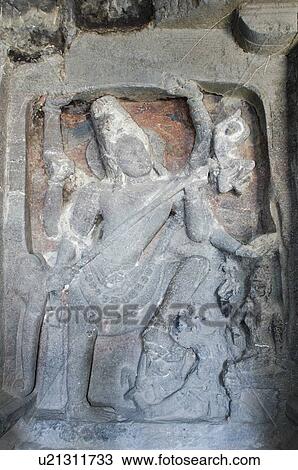Stock Image - Statue of lord Shiva carved in a cave, Ellora, Aurangabad, Maharashtra, India. Fotosearch