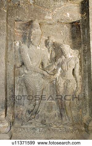 Stock Photo - Statues carved on a wall, Ellora, Aurangabad, Maharashtra, India. Fotosearch
