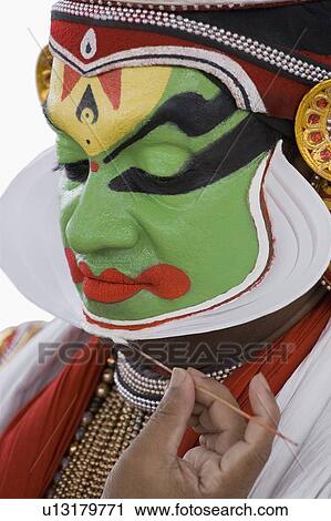 Close-up of a Kathakali dance performer applying make-up on his face View Large Photo Image Stock Image - Close-up of a Kathakali dance performer applying make-up on his face. Fotosearch