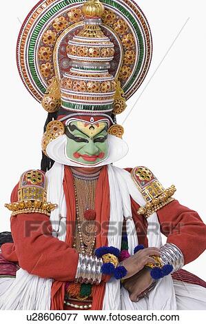 Stock Photo - Close-up of a Kathakali dance performer sitting and looking away. Fotosearch