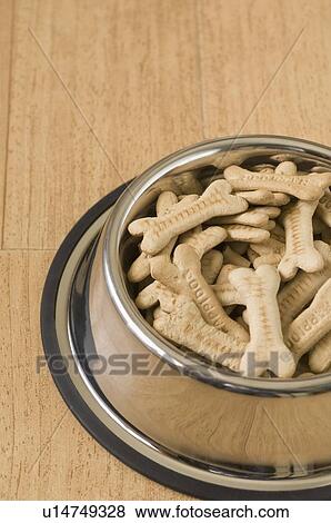 Stock Photo - Close-up of dog biscuits in a dog bowl. Fotosearch