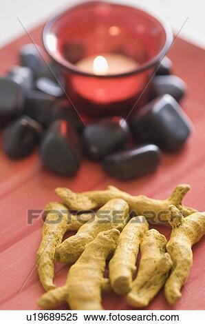 Close-up of an aromatherapy candle burning with black pebbles and turmeric View Large Photo Image Stock Photography - Close-up of an aromatherapy candle burning with black pebbles and turmeric. Fotosearch